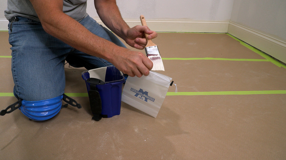 man putting paint brush into the brush saver bag for later use width=